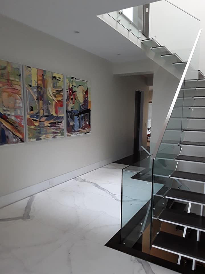 Marble foyer with floating glass and steel staircase, Hamilton Ontario