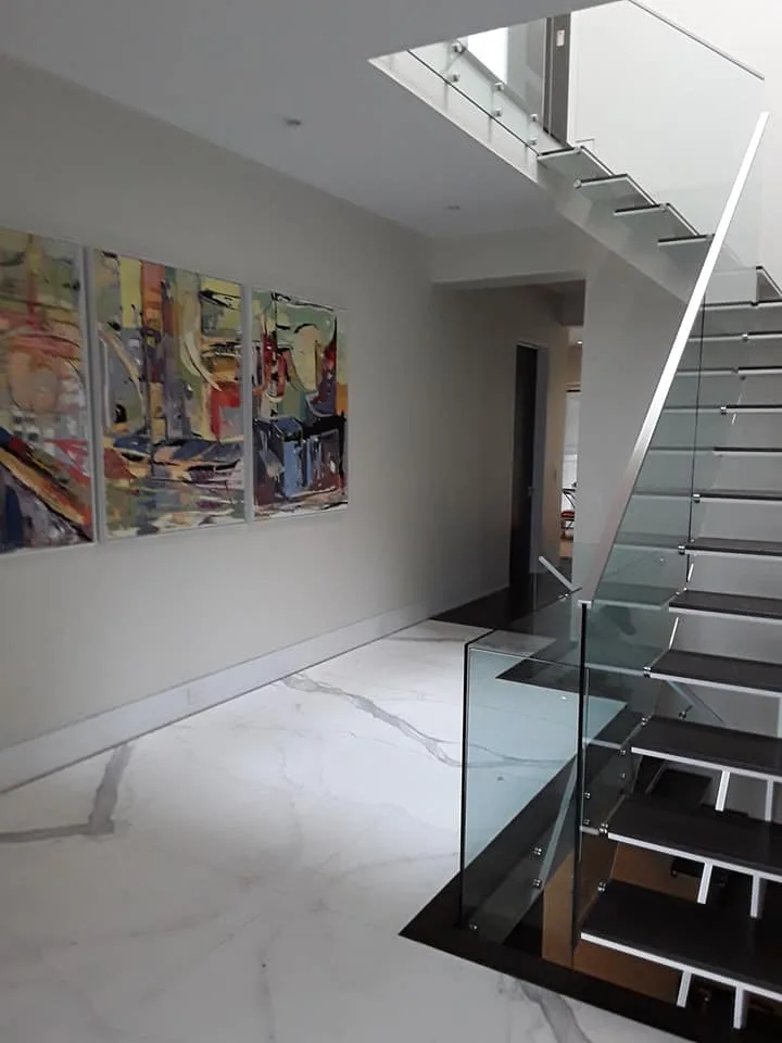 Marble foyer with floating glass and steel staircase, Hamilton Ontario