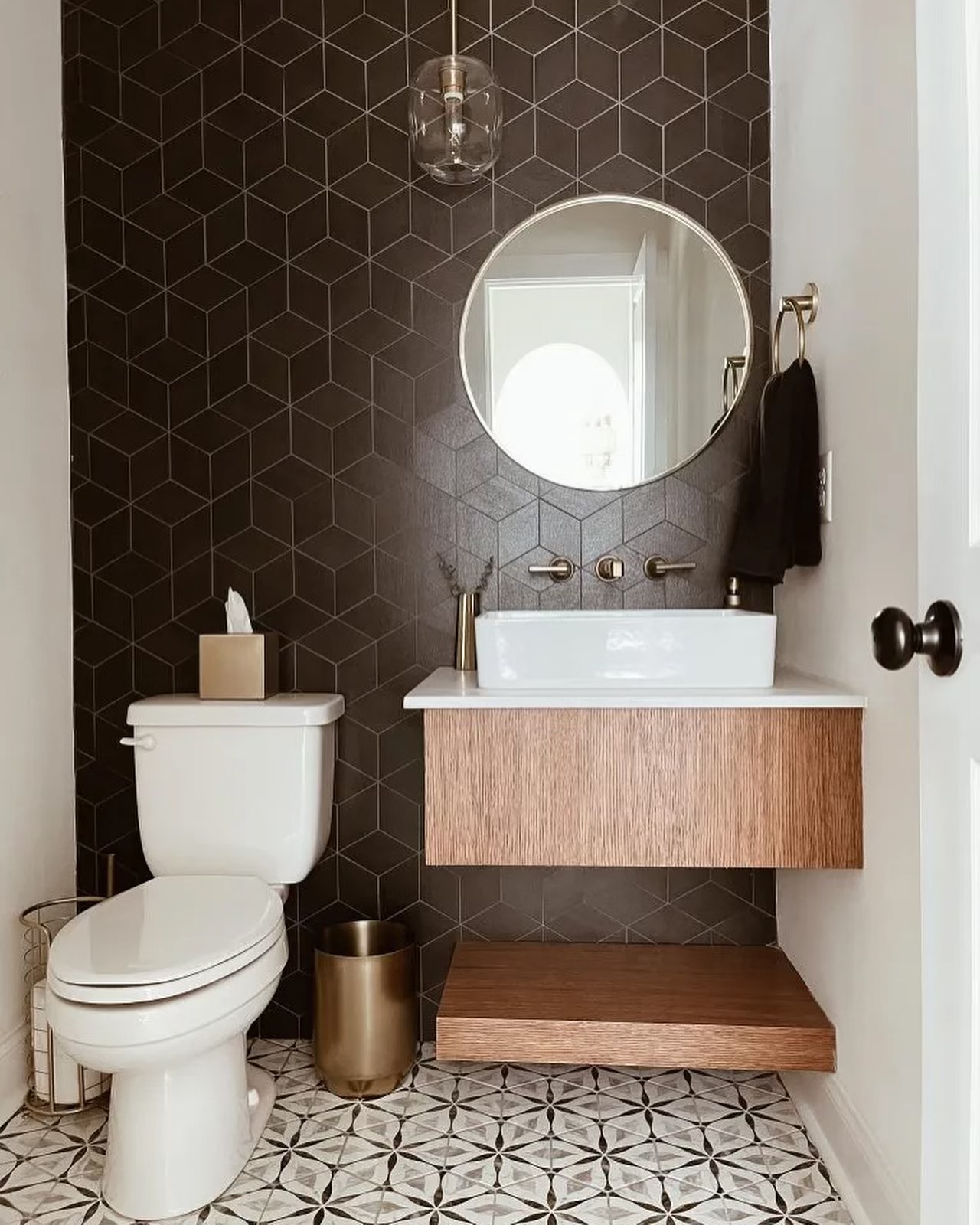 Powder room with black geometric tile accent wall and floating oak vanity, Hamilton Ontario