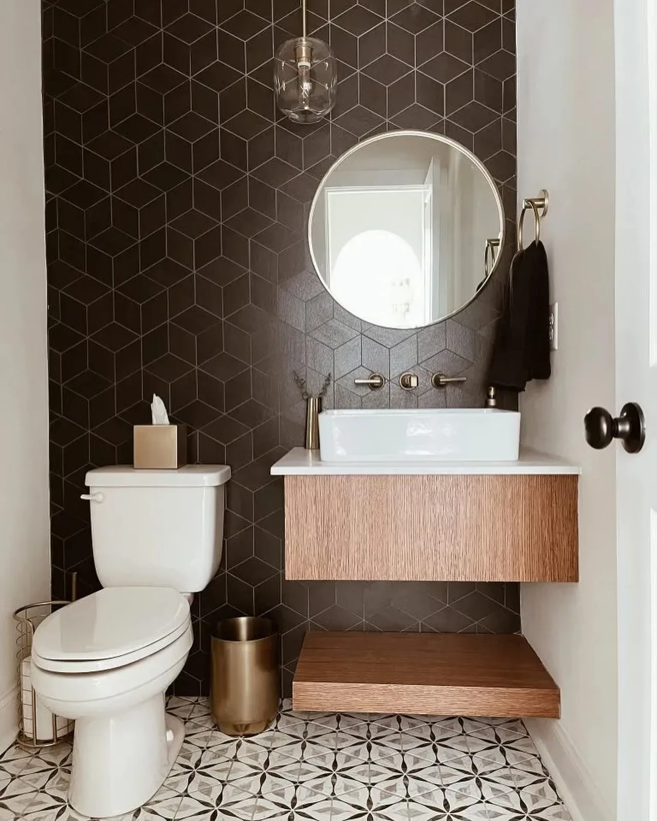 Powder room with black geometric tile accent wall and floating oak vanity, Hamilton Ontario